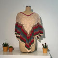 Colorful crocheted poncho on a mannequin with potted plants in the background