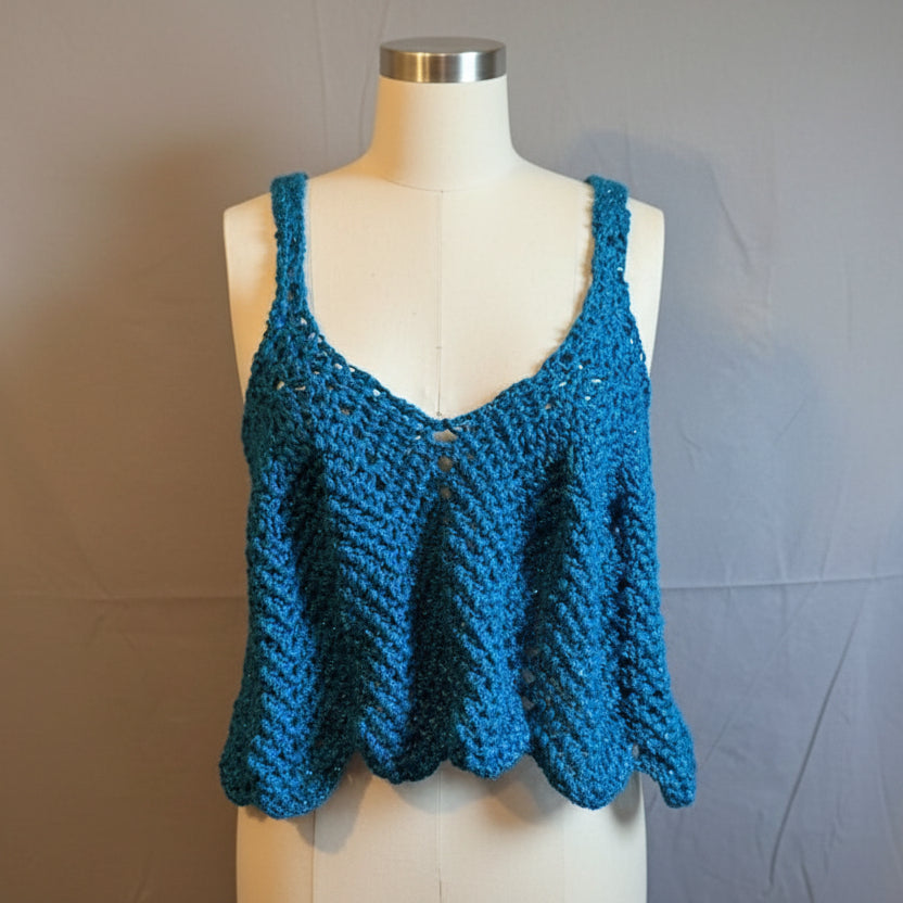 Teal crocheted Viva tank top on a mannequin against a plain background